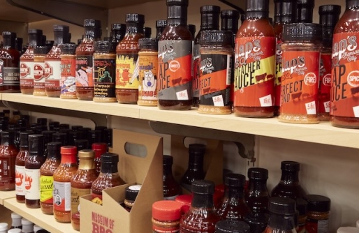 displays of barbecue sauce on wooden shelves