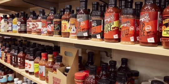 Variety of Bottles of BBQ Sauce on Wooden Shelving